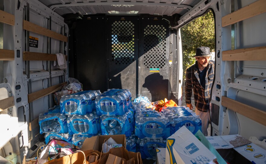 Dozens of volunteers based out of an old church youth center organize food and clothing supplies before heading out to the camps near Jacumba, Calif., on Nov. 11.