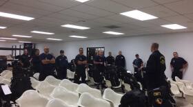 Members of the San Diego Urban Search and Rescue (CA-TF8) gear up before heading to Texas to assist after Hurricane Harvey, Aug. 27, 2017. 