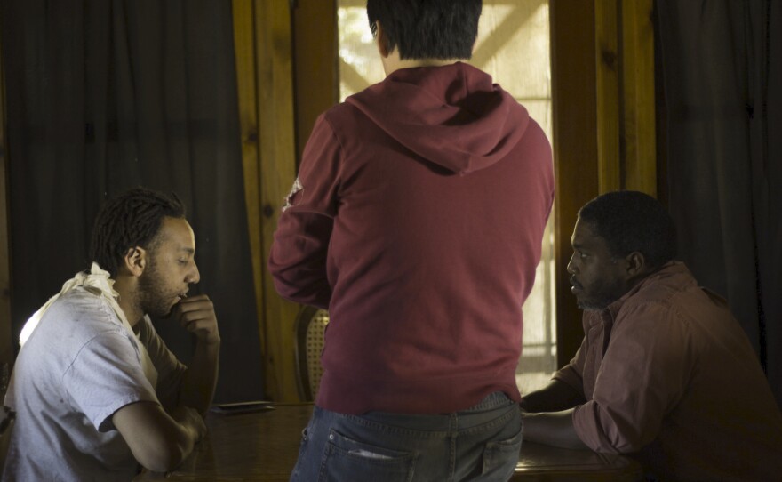 Filmmaker Marvin Choi (back to camera) with actors Darnel Powell and Joseph Price on the set of "A Knight's Tour."