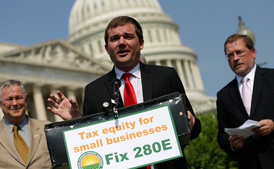 Aaron Smith, executive director of the National Cannabis Industry Association, speaks about taxes on marijuana outside the Capitol in 2013. "Any industry that is heavily regulated by the government has to have an active voice," the group's deputy director recently said.