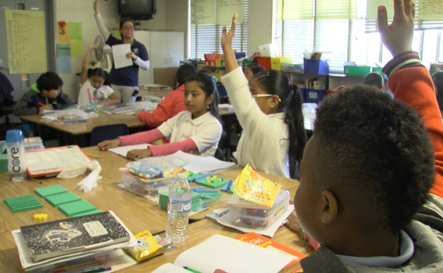 Donnell Branch, right, raises his hand in his Perkins Elementary Schoool fourth-grade classroom, March 2, 2017.