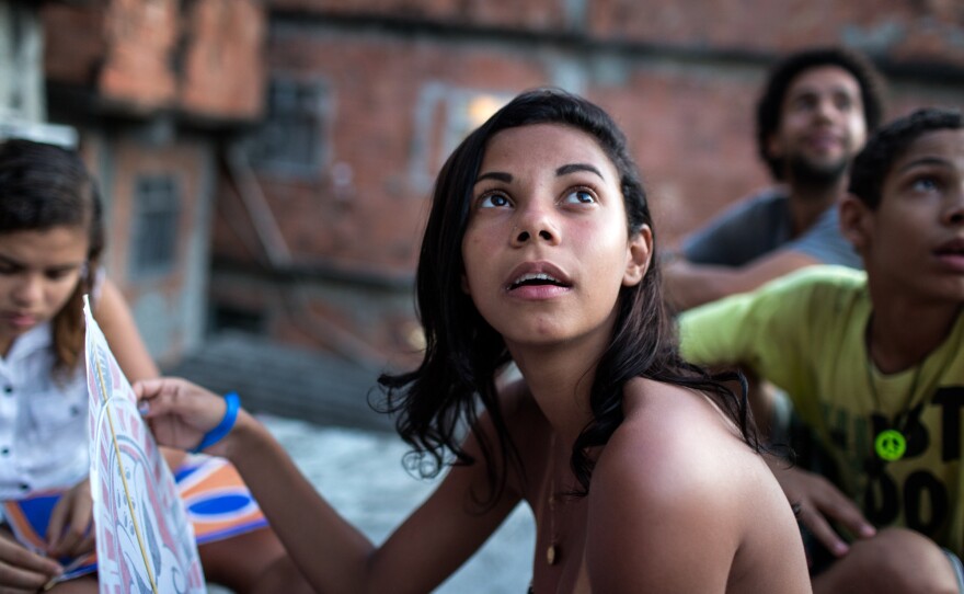 Lala, left, and Milena try launching a kite.