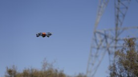 An unmanned aircraft is shown flying near a tower carrying long-distance electric transmission lines near Boulevard in eastern San Diego County.