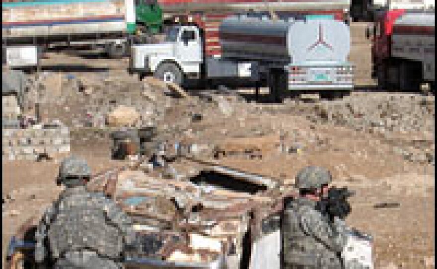 U.S. soldiers with the 2-7 Cavalry take up positions during a raid in southwestern Mosul.
