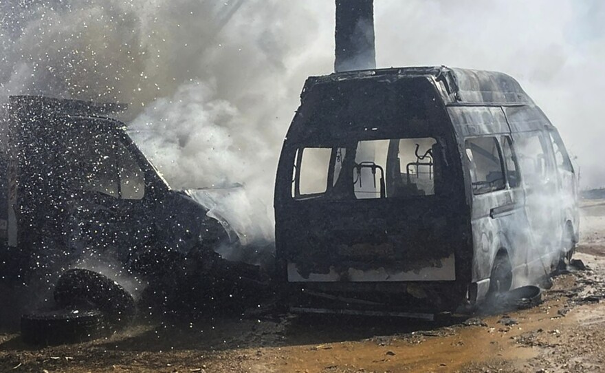 A truck and ambulance burn after Israeli airstrikes hit a group of paramedics outside a hospital in Marjayoun, southern Lebanon on Oct. 4, 2024.