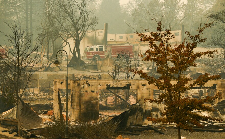 A fire truck drives through an area burned by the Camp Fire in Paradise on Tuesday.