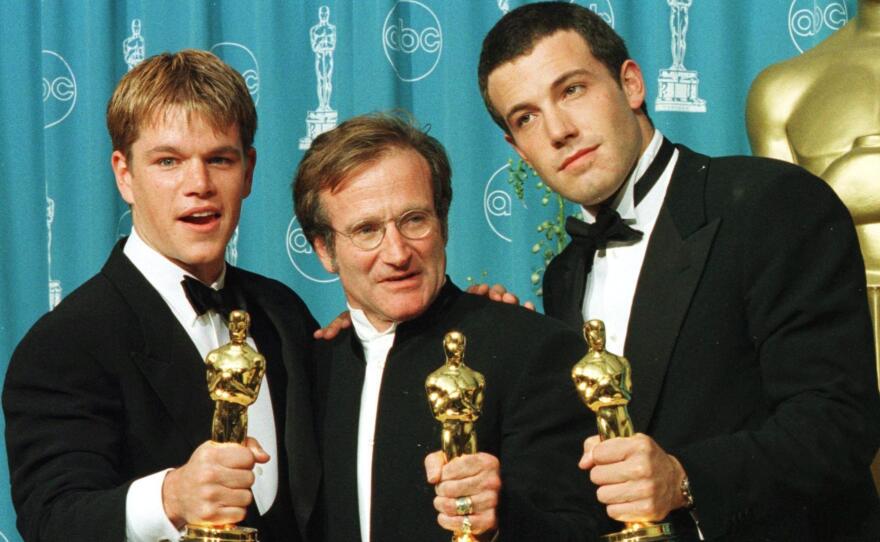 Actor-writers Matt Damon (left) and Ben Affleck pose with Williams holding the Oscars they won for Good Will Hunting at the 70th Annual Academy Awards in 1998.