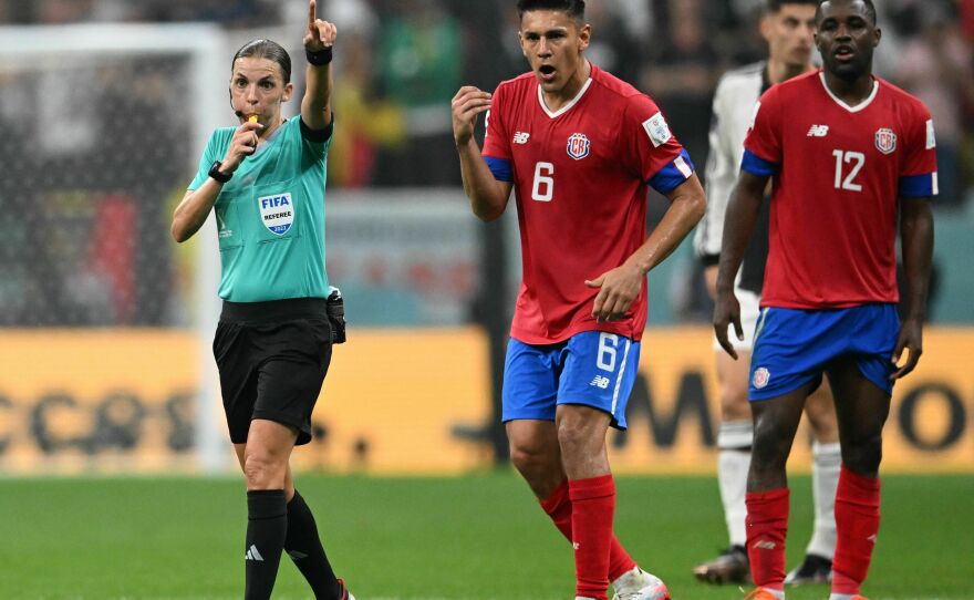 French referee Stephanie Frappart gestures next to Costa Rica's defender #06 Oscar Duarte and Costa Rica's forward #12 Joel Campbell during the Qatar World Cup match between Costa Rica and Germany on December 1, 2022.