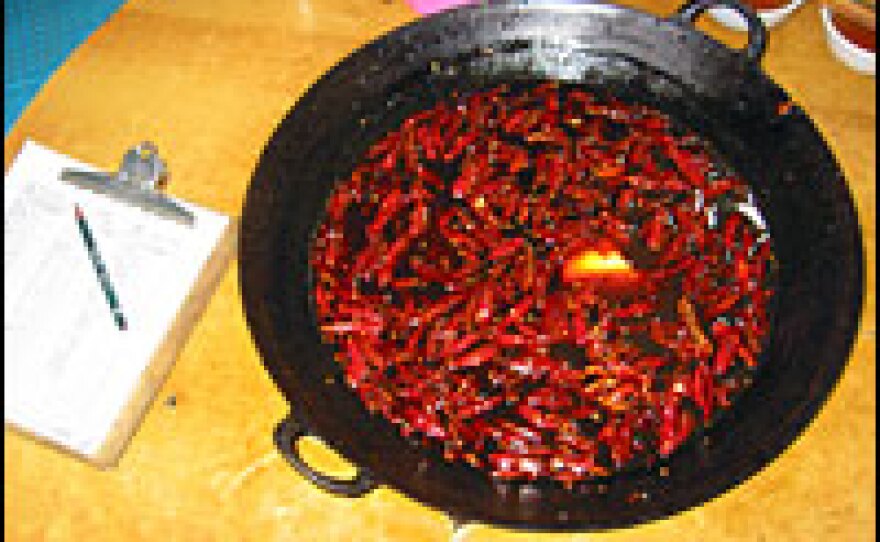 A boiling pot of canola oil, chili peppers and prickly ash is the centerpiece of a Sichuan-style hot pot meal at Second Son Zhao's Hot Pot restaurant in Chongqing, China.