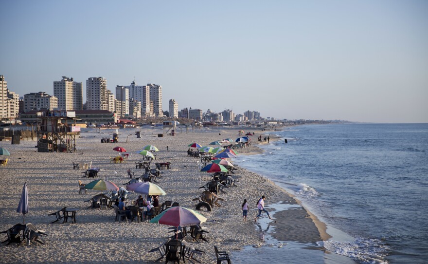 Families and friends enjoy their time on a Gaza City beach. Israel allows in international aid workers, journalists and diplomats, but tourists are prohibited.