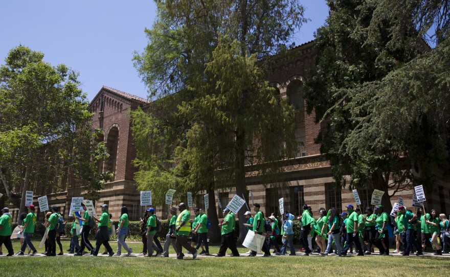 Protesters march on the UCLA campus Monday in Los Angeles, demanding solutions to gender pay inequity and higher wages. It was the first of three days of walkouts by service workers at University of California campuses.