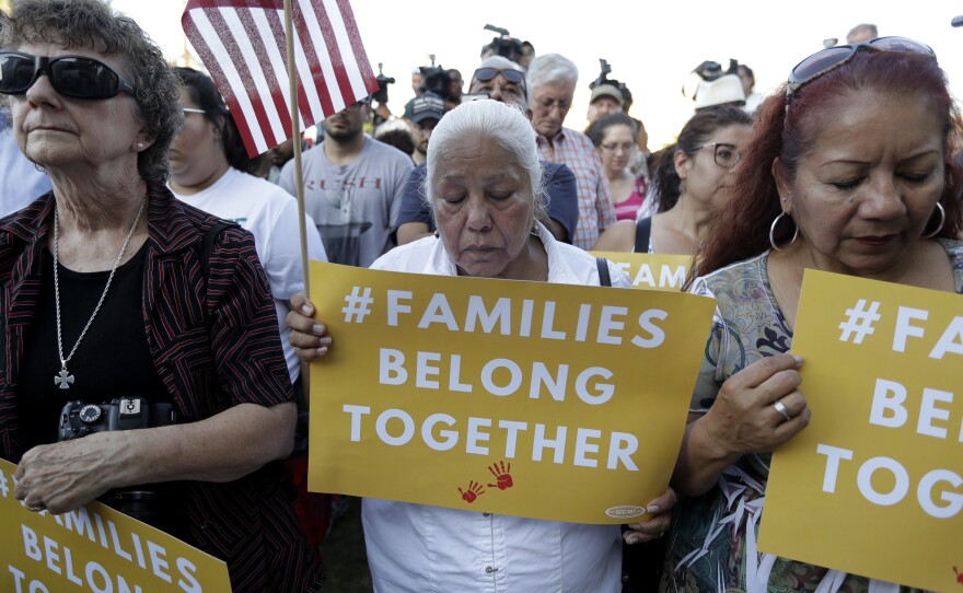 Protesters in San Antonio pray during a Rally For Our Children event to protest the Trump administration's "zero-tolerance" immigration policy.