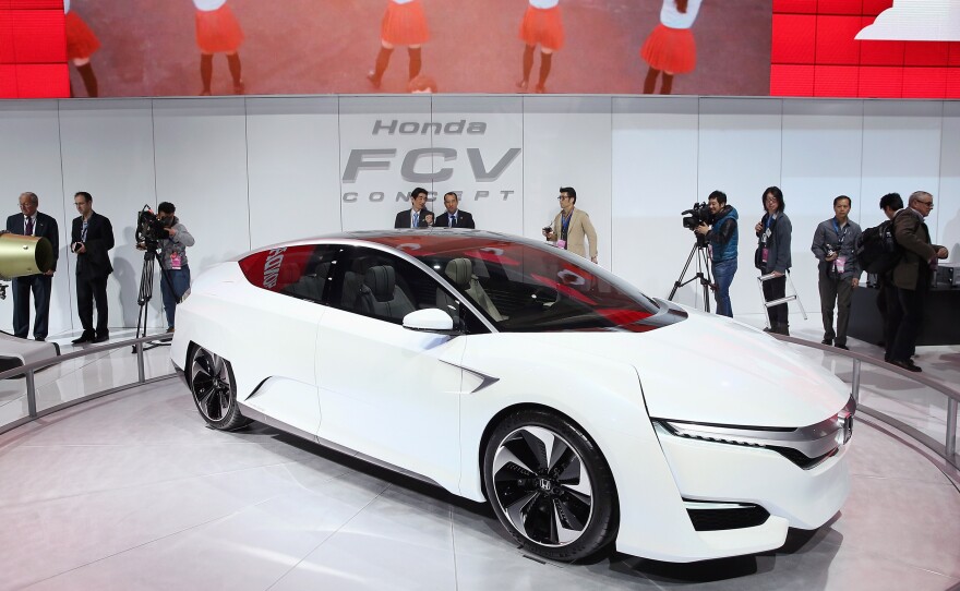 Guests look over the Honda FCV fuel cell powered concept car during the media preview.