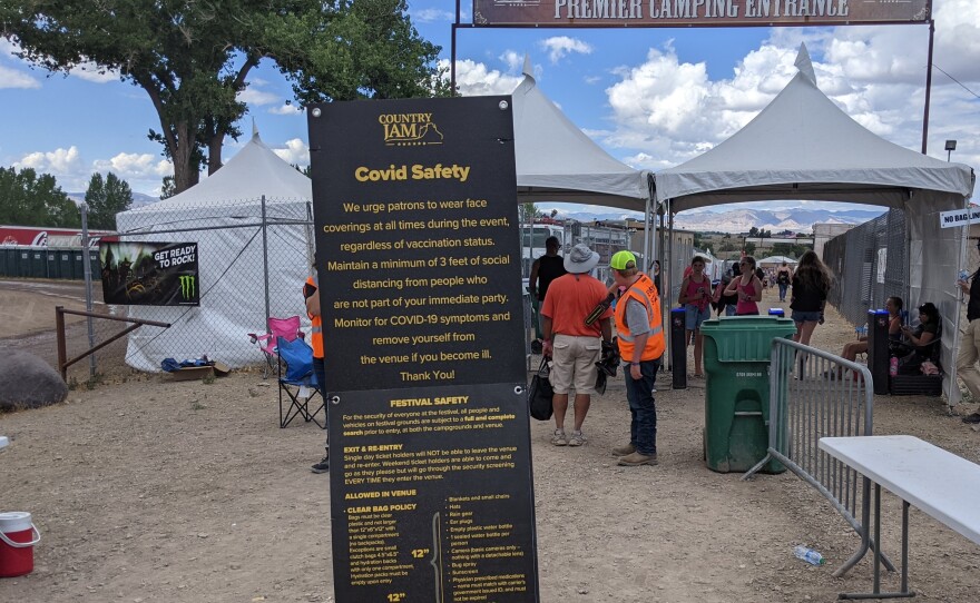 A sign urged Country Jam concertgoers to wear masks regardless of their vaccination status. Most did not.