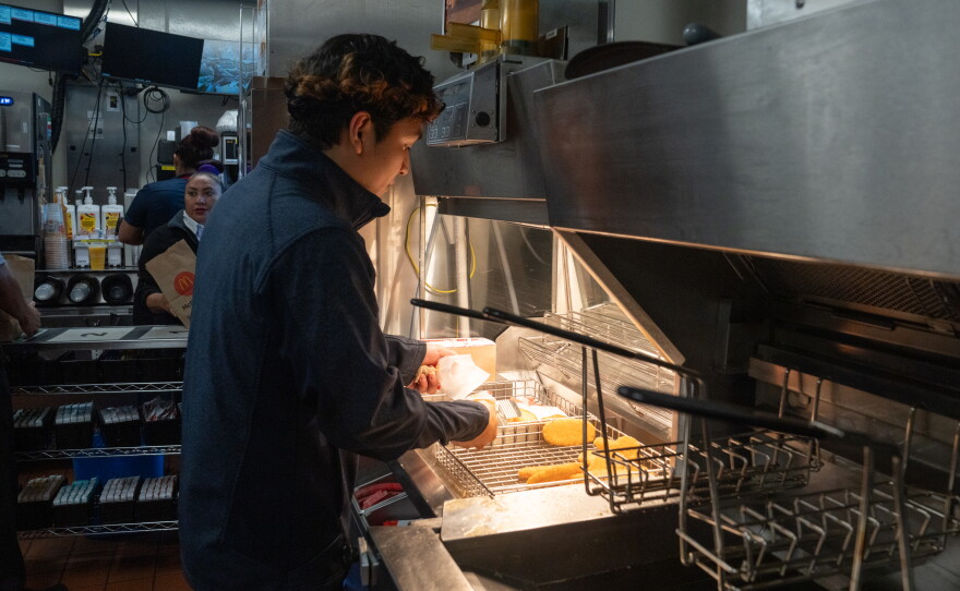 Kitchen manager Jason Guevara prepares hash browns during a morning shift.