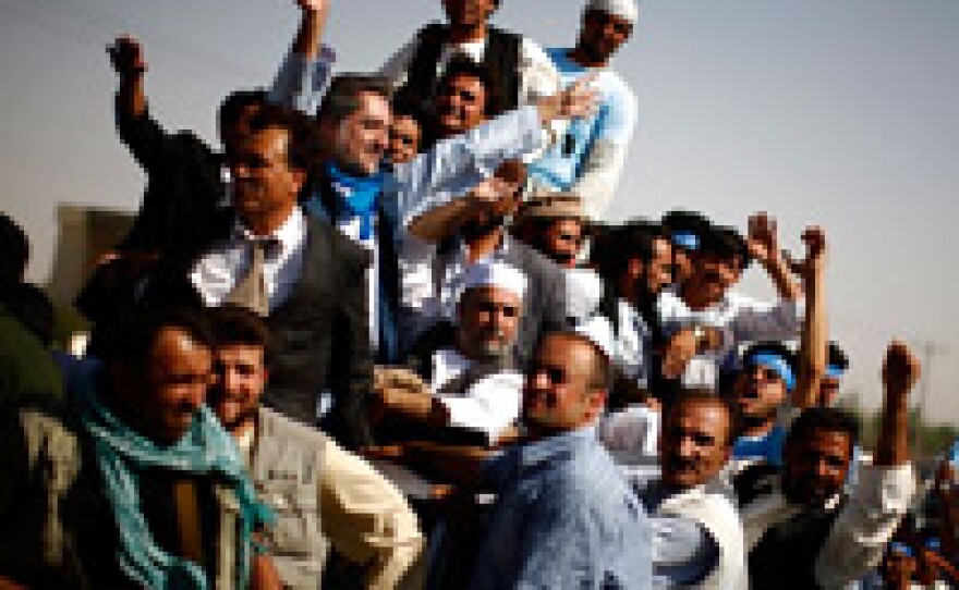 Campaigning among the 41 candidates for Afghanistan's presidential election on Aug. 20 is beginning to ramp up. Here, supporters of candidate and former Foreign Minister Abdullah Abdullah, center, ride on top of an SUV while trying to make their way from the airport to Herat, Afghanistan, July 17, 2009.