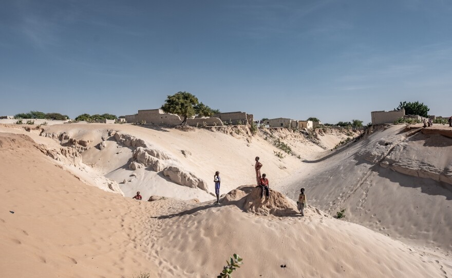 Boys stand on the edge of the town of Mao in Kanem Province, Chad, where desertifcation and land degradation are an increasing threat to the ability of locals to grow food. Some 135 million people in the region rely on the degraded land.