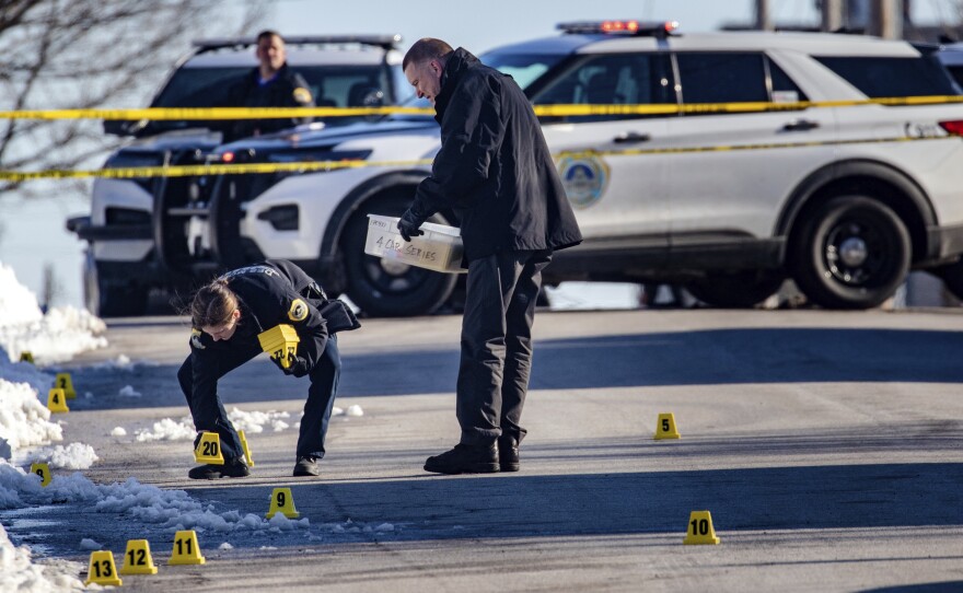 Police investigate a fatal shooting outside of East High School in  Des Moines, Iowa, on Monday. Police said it was the fourth homicide in Des Moines this year.