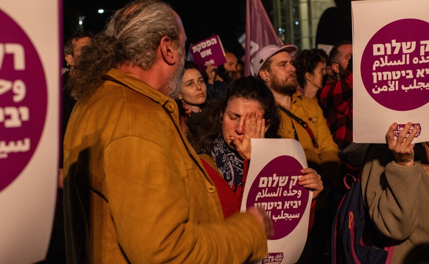 Demonstrators hold signs saying "Only peace will bring security," at a rally in Tel Aviv, Israel, calling for an end to the war between Israel and Hamas.