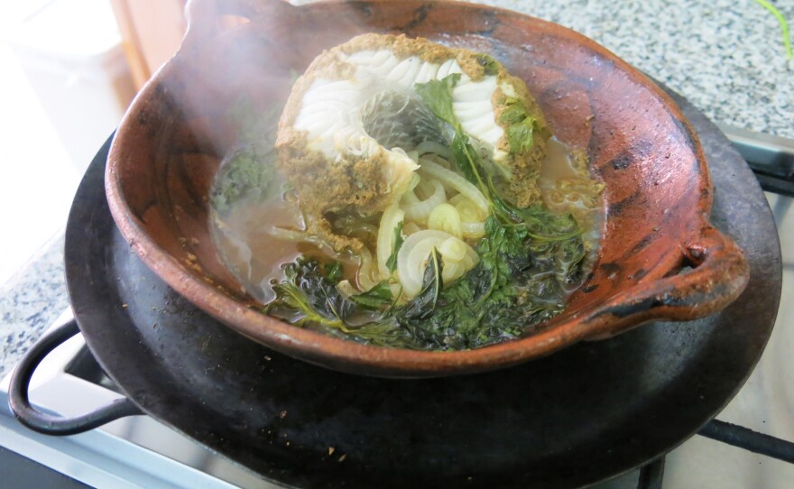 Carrillo and NPR's Carrie Kahn cooked <em>robalo</em>, or local snook, a firm white fish, in <em>chintextle</em>, a smoked chili paste.