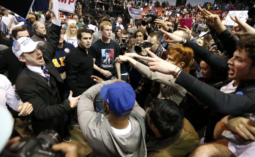 Supporters of Republican presidential candidate Donald Trump (left) face off with protesters after a rally on the campus of the University of Illinois-Chicago was cancelled due to security concerns on Friday in Chicago.