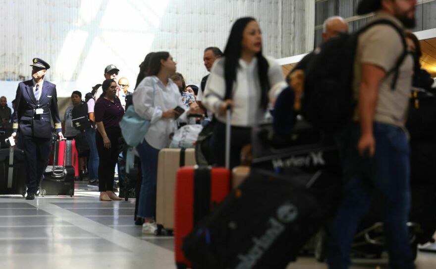 Travelers and their luggage in a terminal at Los Angeles International Airport in August 2023.