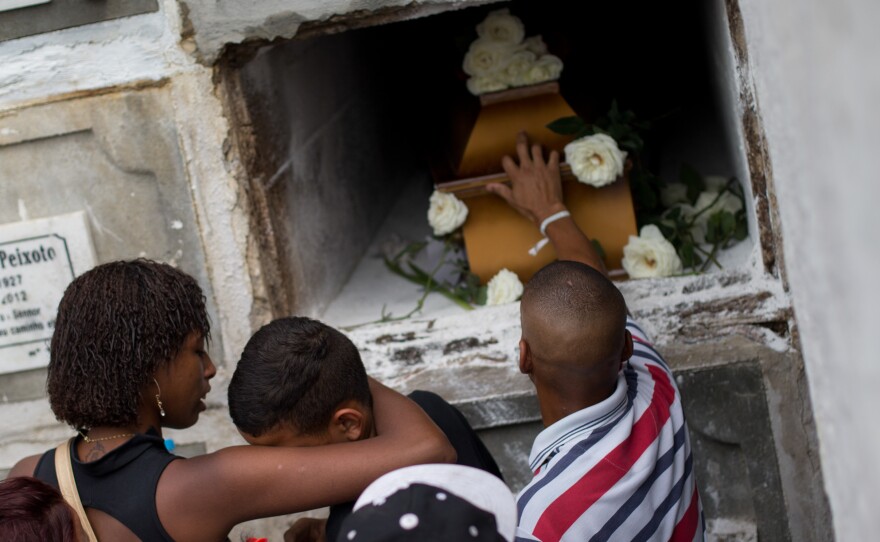 Relatives and friends of Eduardo Felipe Santos Victor, a teenager who was shot dead in Morro da Providencia, a low-income favela community, mourn during his funeral in Rio de Janeiro, on Sept. 30, 2015.