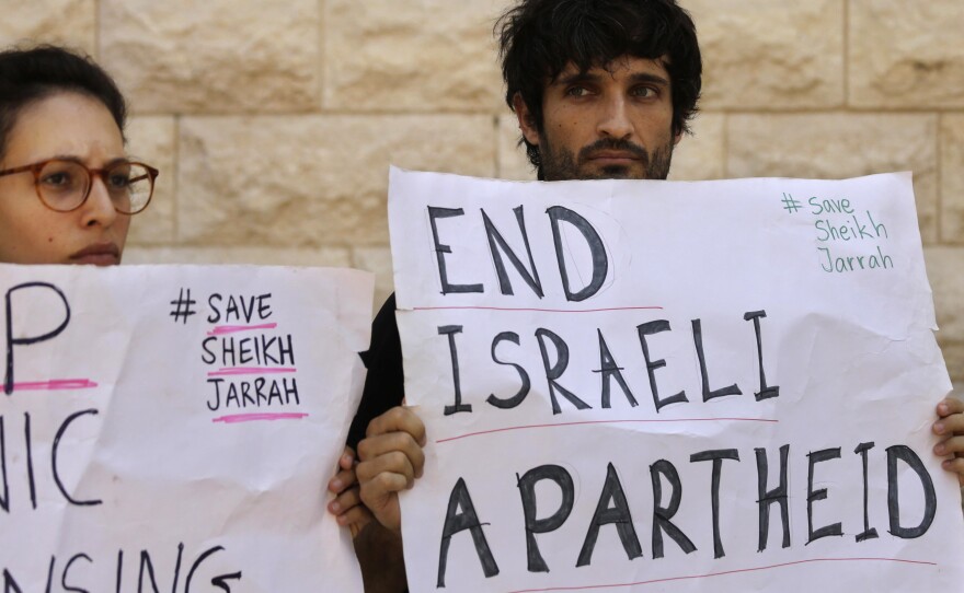 Protesters hold signs during a hearing on the possible evictions of Palestinians from the Sheikh Jarrah neighborhood of Jerusalem, outside the Israeli Supreme Court in Jerusalem on Monday, Aug. 2, 2021.