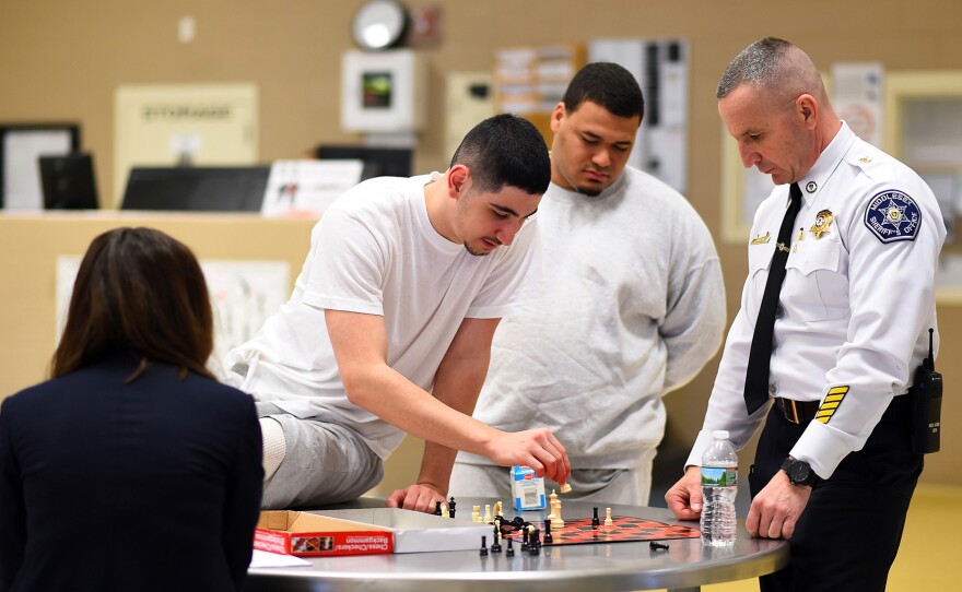 Middlesex County Correctional Facility Assistant Deputy Superintendent Scott Chaput with inmates in the prison's P.A.C.T (People Achieving Change Together) unit in Billerica, Mass.