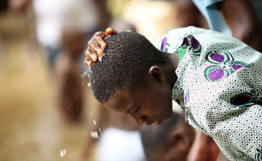 A young man performs ritualistic washing at the Sacred Grove during the Osun-Osogbo festival.