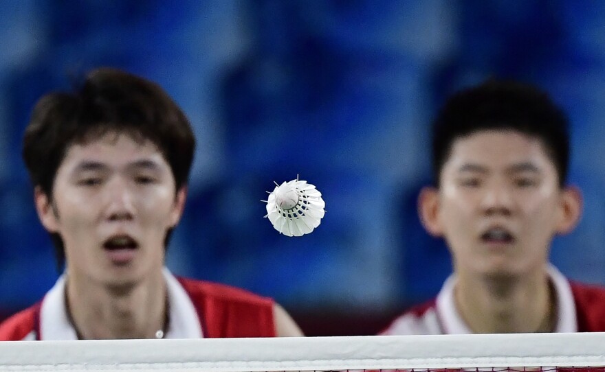 China's Li Junhui, left, and China's Liu Yuchen watch the shuttlecock during their men's doubles badminton semi-final match against Malaysia's Soh Wooi Yik and Malaysia's Aaron Chia on July 30, 2021.