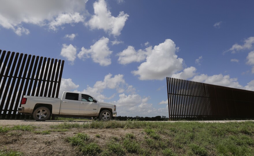 A farmer passes along a border fence that divides his property in Mission, Texas. The state alone shares more than 1,200 miles of border with Mexico.