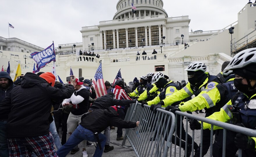 Trump supporters try to break through a police barrier on Wednesday at the U.S. Capitol in Washington.