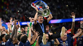 PSG's head coach Luis Enrique, top, celebrates with players after winning the Champions League final soccer match against Arsenal in Budapest, Hungary, Saturday, May 30, 2026.