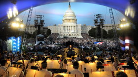 Maestro Erich Kunzel conducts the National Symphony Orchestra before a crowd of thousands attending the National Memorial Day concert at the U.S. Capitol. 