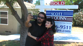 Jennifer and James Van Winkle pose by the sold sign outside of their house in San Diego, October, 2016.