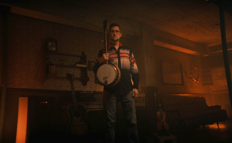 Joe Troop poses with his banjo.