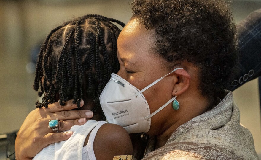 Natasha Greaves holds her daughter, Laila Greaves, 5, after Laila received a Pfizer-BioNtech COVID-19 vaccine on Wednesday in Shoreline, Wash.