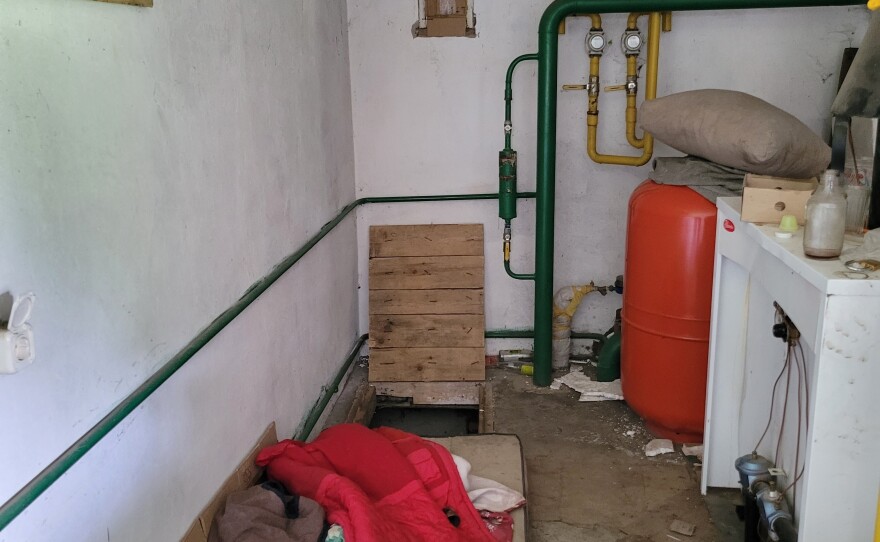 An interior look at left-behind items in the abandoned building where locals believe Viktoria Andrusha was held. In the back is a trap door to the cellar where two men were also held.