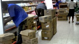 Workers stock the Big Star Market in Port-au-Prince's upscale suburb of Petionville.
