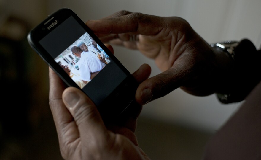 El-Amin shows a photo of his release from prison. Now 60 years old, he served 42 years in prison for murder before he was freed on probation in 2013.