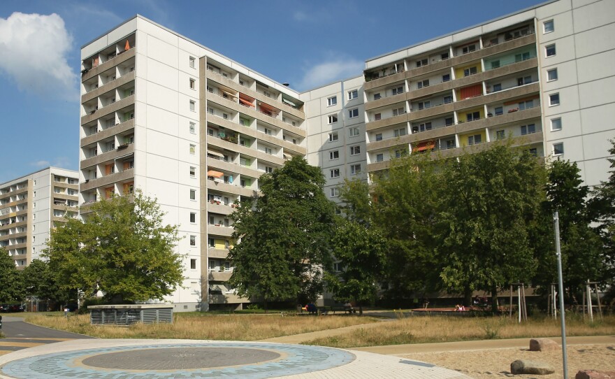 A child plays near communist-era apartment blocks in Hoyerswerda, Germany. After the collapse of the communist East German government that had redeveloped the area into an industrial hub, factories shut down and coal production declined. The population has sunk below 33,000 — about half its size before the fall of the Berlin Wall.