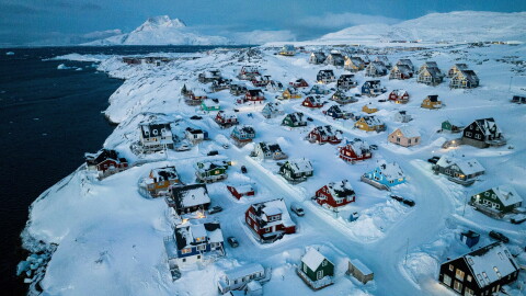 Houses covered in snow are seen on the coast of a sea inlet of Nuuk, Greenland, March 7, 2025.