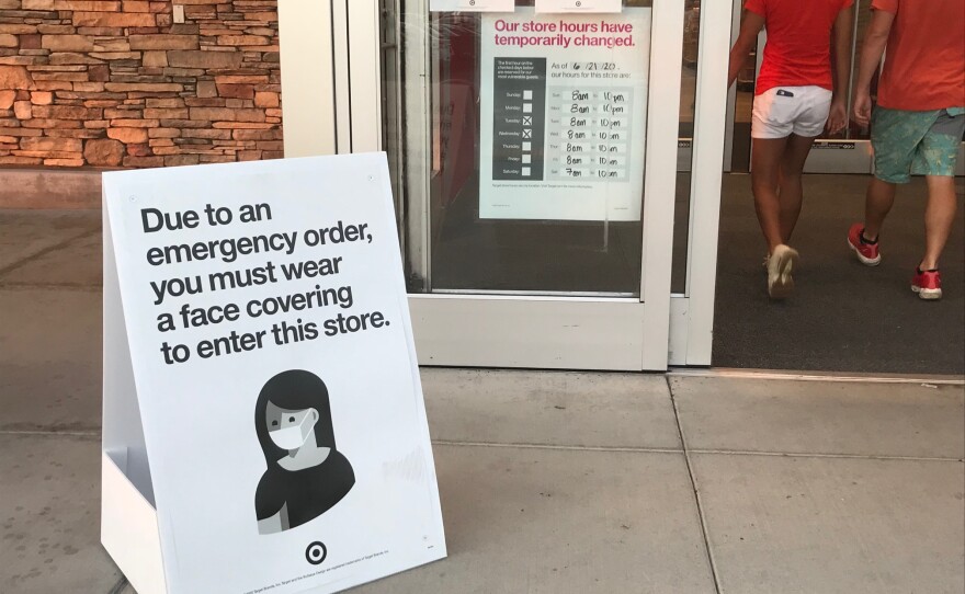 A sign indicating the store's coronavirus prevention policies sits outside the entrance of Target in the Clairemont neighborhood of San Diego County. Oct. 16, 2020.