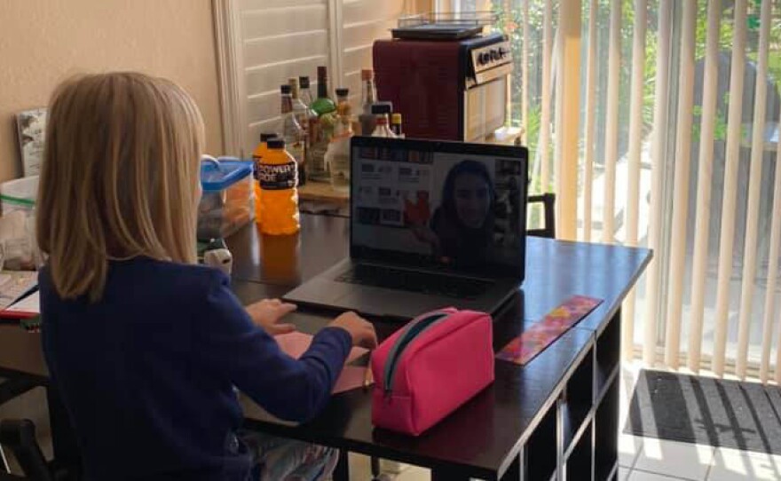 San Diego child of a military family  listens to a virtual storytelling session provided by the USO.