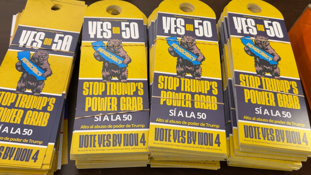 Door hangers in support of Prop 50. They read "Stop Trump's Power Grap" and "Alto al abuso de poder de Trump"