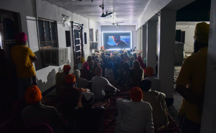 Villagers watch a special screening of the film "Satluj" at a Sikh temple at Tatley village, in Punjab's Gurdaspur district, India, Wednesday, July 8, 2026.