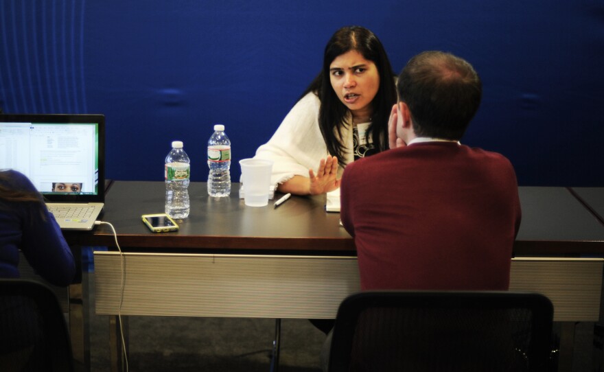 Elsamarie D'Silva, an Aspen fellow from India who focusses on gender based violence and harassment, speaks with a reporter during the speed dating session.