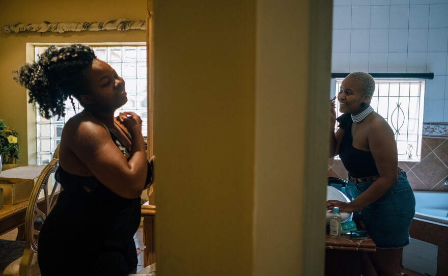 Cousins Mpho Rantao, 21, (left) and Ntaoleng Mokotini, 21, apply makeup in preparation for the Afropunk Joburg event later that day.