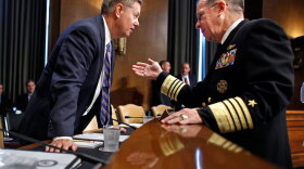 Adm. Mike Mullen, chairman of the Joint Chiefs of Staff, talks with Sen. Lindsey Graham (R-SC) before testifying before the Senate Armed Services Committee on Tuesday. Mullen told the panel that success in Afghanistan "probably means more forces."